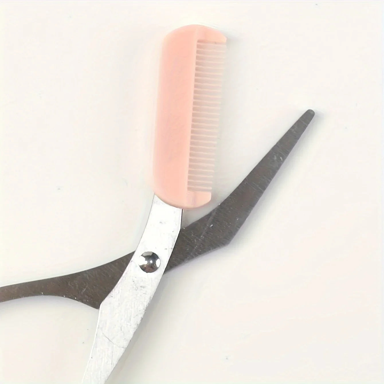 Pink eyebrow trimming scissors with built-in comb - stainless steel, precise grooming tool, creating perfect eyebrows
